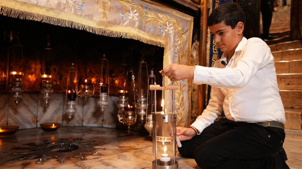 Jeries Fadi Khier, undicenne di Betlemme, accende la Luce della Pace dell'ORF nella Grotta della Natività. Credits: friedenslicht.orf.at
